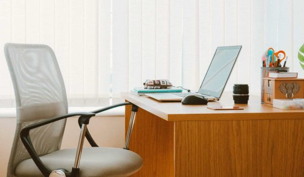 Office desk with computer, chair, and office supplies in South Africa.