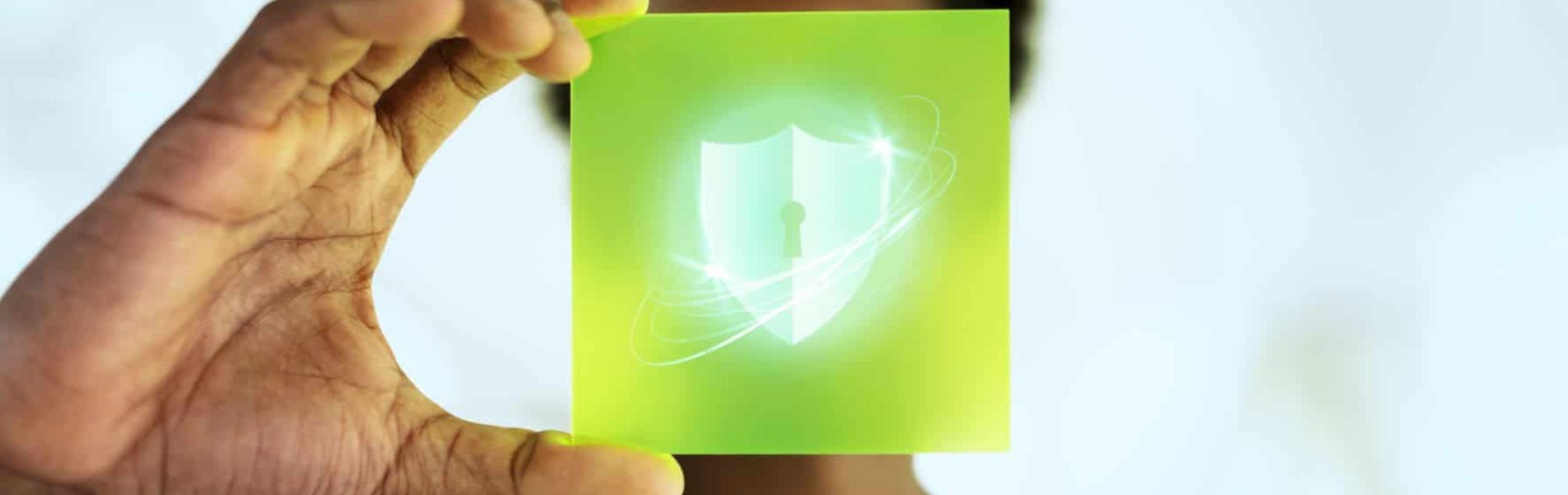 Person holding a shield icon representing security levels for shredders.