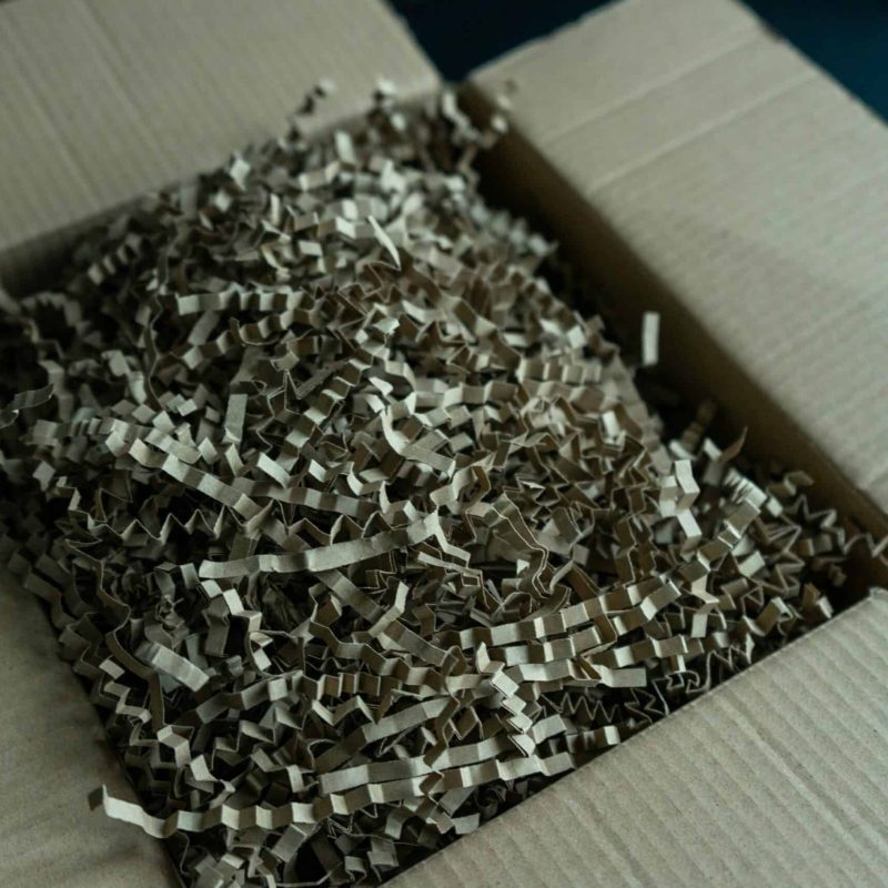 Shredded paper inside a cardboard box for secure disposal or recycling.